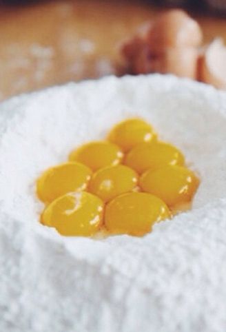 Egg yolks in a well of flour, the start of the house-made pasta dough