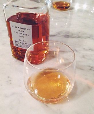 A glass of Nikka From the Barrel whisky poured over ice at the bar