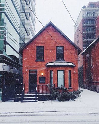 The restaurant's red brick house on Nepean Street during a snowfall